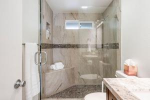 a bathroom with a shower with a toilet and a sink at Avengers HQ - Hot Tub - Close to Disney - Parking in Anaheim +55 photos