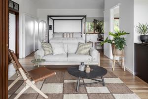 a living room with a couch and a bed at Cape Vue - Vue 2 Byron Bay in Ewingsdale
