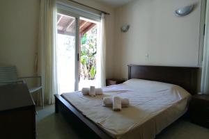 a bedroom with a bed with towels on it at Bungalow Sea Paradise - Beachfront Escape with Sea View in Polis Chrysochous