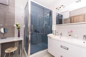 a bathroom with a glass shower and a sink at Agava Lux in Trogir +33 photos