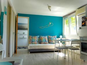 a living room with a couch and a blue wall at Bodorka - Csak a Tiéd! in Balatonakarattya