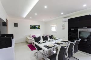 a dining room and living room with a table and chairs at Agava Lux in Trogir