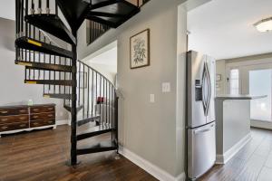 a hallway with a spiral staircase and a refrigerator at Haymount Hideaway in Fayetteville