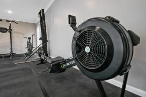 a gym with a fan and several tread machines at Haymount Hideaway in Fayetteville