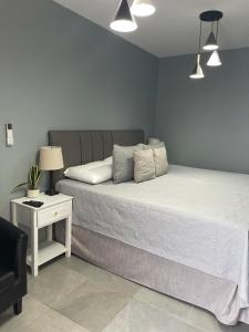 a bedroom with a bed and a table with a lamp at Ayari Bed & Breakfast in Guatemala