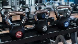 a row of black dumbbells in a gym at 4 Bedroom Cable Beach Condo with Balcony in Nassau