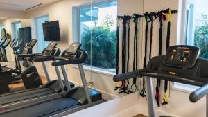 a gym with several tread machines and a window at 4 Bedroom Cable Beach Condo with Balcony in Nassau