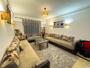 a living room with a couch and a table at Majorelle Apartment 1- Bedroom 1-Terrace Centre in Marrakech