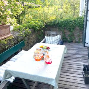 a white table with drinks and fruit on a patio at Haus am Bach in Fischbachau +33 photos