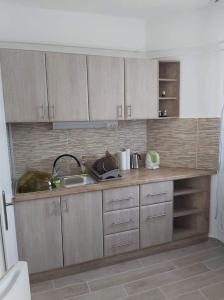 a kitchen with a sink and a counter top at Ancsi-Lak Tapolca in Tapolca +6 photos