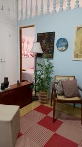 a room with a bed and a chair and a table at Espaço DéboraMa&Deise in Rio de Janeiro