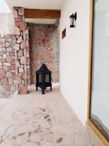 an empty hallway with a brick wall and a fireplace at El Callejón PLATA in Real de Catorce