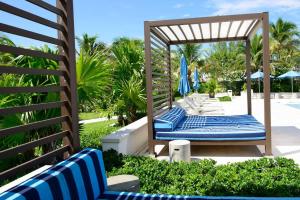 a group of blue chairs under a gazebo at Cable Beach Condo Large private patio with BBQ in Nassau