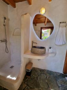 a bathroom with a sink and a mirror at Fay's Guesthouse Aegina in Egina +15 photos