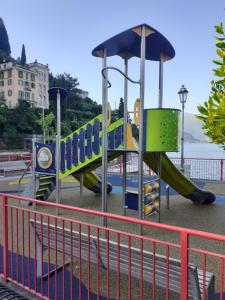 a playground with a slide and an umbrella at CASA IN RIVA AL LAGO in Varenna