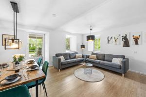 a living room with a couch and a table at NA-Home Melcherhof in Grafenstein