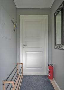 a white door in a room with a mirror at Haugane in Selje