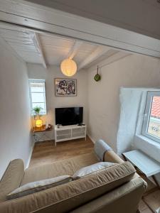 a living room with a couch and a tv at Casa Farito Muros in Muros