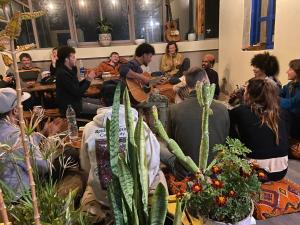 a group of people sitting around a table with plants at Olas Surf Camp in Imsouane