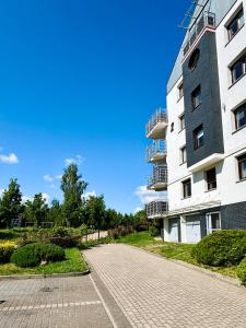 an empty street in front of a building at Sunny Apartment Bydgoszcz in Bydgoszcz +18 photos