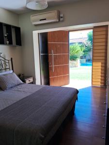 a bedroom with a bed and a sliding glass door at CASABLANCA CATAMARCA Guest House in San Fernando del Valle de Catamarca
