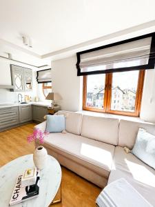a living room with a couch and a table at Sunny Apartment Bydgoszcz in Bydgoszcz