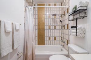 a bathroom with a tub and a toilet and a shower at Fountain Historic Villa Old San Juan by PH in San Juan +61 photos