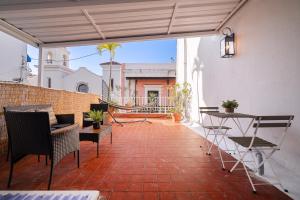 a patio with chairs and a hammock on a balcony at Fountain Historic Villa Old San Juan by PH in San Juan