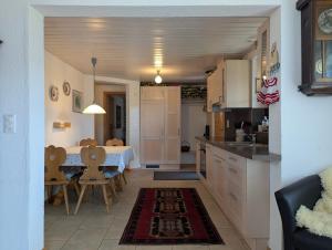 a kitchen and dining room with a table and a dining room at Casa Acazia in Breil/Brigels