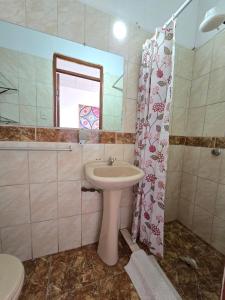 a bathroom with a sink and a toilet and a mirror at Holistic Scandinavia House in Arequipa +55 photos
