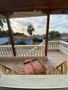 a patio with chairs and a table on a balcony at Evilion- Potidaia- Halkidiki- 100m from the sea in Nea Potidaea