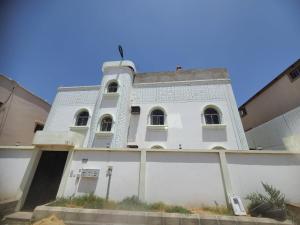 a white building with a gate in front of it at شقة 3 احد رفيدة حي الخليج in Ahad Rafidah