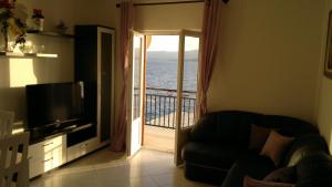 a living room with a door leading to a balcony at House Racic in Bol