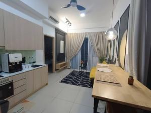 a large kitchen with a table and a counter top at The Luxe Colony KLCC by Sky Pool in Kuala Lumpur