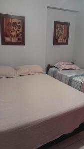 two beds sitting next to each other in a room at BOA VIAGEM PROX AO MAR in Recife +18 photos