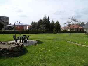a park with two chairs and a table in the grass at Apartment Zum Keulenbergblick in Laußnitz