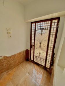 an open door in a room with a tile floor at Yellow House on the Nile in Luxor +48 photos