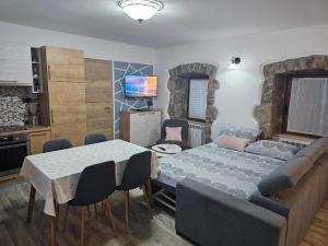a living room with a table and a couch at Villa Kos in Lupoglav
