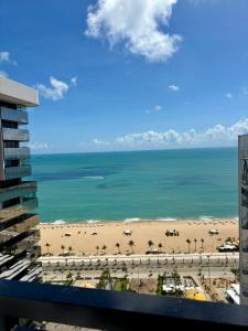 a view of the beach from the balcony of a building at Hotel Brasil Tropical in Fortaleza