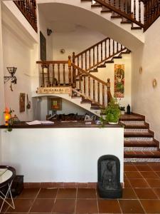a staircase in a house with a stair case at Hostal Altajo con Restaurante, Naturaleza & Descanso en el Alto Tajo in Peralejos de las Truchas