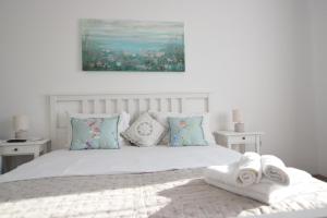 a bedroom with a bed with two towels on it at Mango 65 Apartment Olimp - Sara Sea View in Olimp
