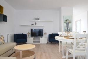 a living room with a couch and a table and a tv at Mango 65 Apartment Olimp - Sara Sea View in Olimp