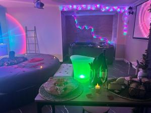 a room with a table with a green vase and lights at Loft Paradis ~Jacuzzi privatif~ Séjour amour in Vieille-Toulouse +4 photos
