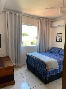 um quarto com uma cama azul e uma janela em Casa 2 Suites, Niterói Região Oceanica em Niterói mais 27 fotografias