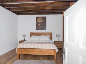 a bedroom with a bed with a statue on the wall at Casa da Gandarela in Soajo