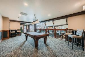 a pool table in a room with a balcony at Best Mtn View-Ski In Ski Out & Gondola to Downtown in Breckenridge