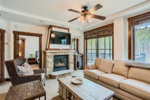 a living room with a couch and a fireplace at Best Mtn View-Ski In Ski Out & Gondola to Downtown in Breckenridge