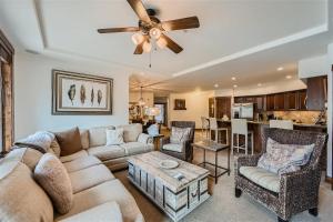a living room with a couch and a ceiling fan at Best Mtn View-Ski In Ski Out & Gondola to Downtown in Breckenridge +26 photos