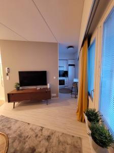 a living room with a large flat screen tv at Studio from Downtown with Sauna in Kuusamo