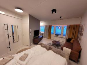a living room with a large bed and a couch at Studio from Downtown with Sauna in Kuusamo